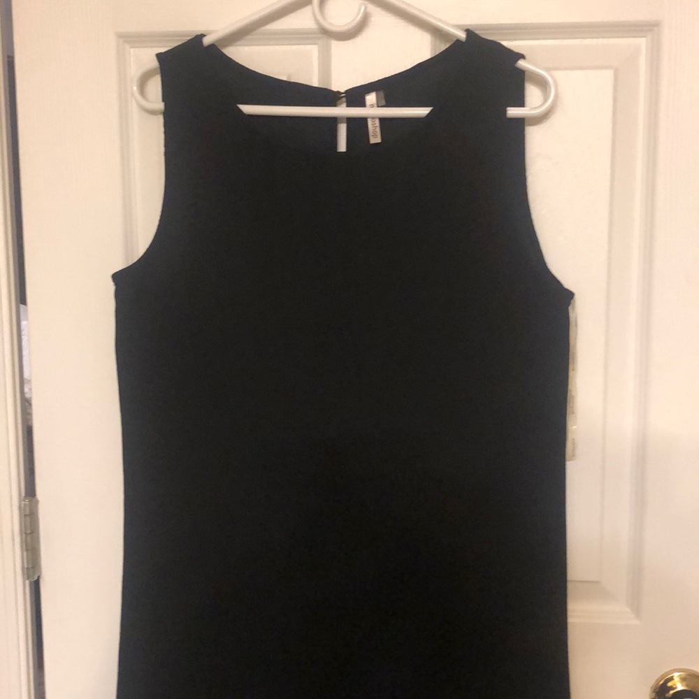 Simple black dress with scallop bottom. Mid knee